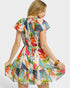 Woman wearing a colorful patterned dress on a white background