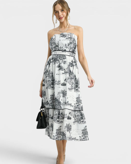 Woman wearing a black and white floral dress on a white background