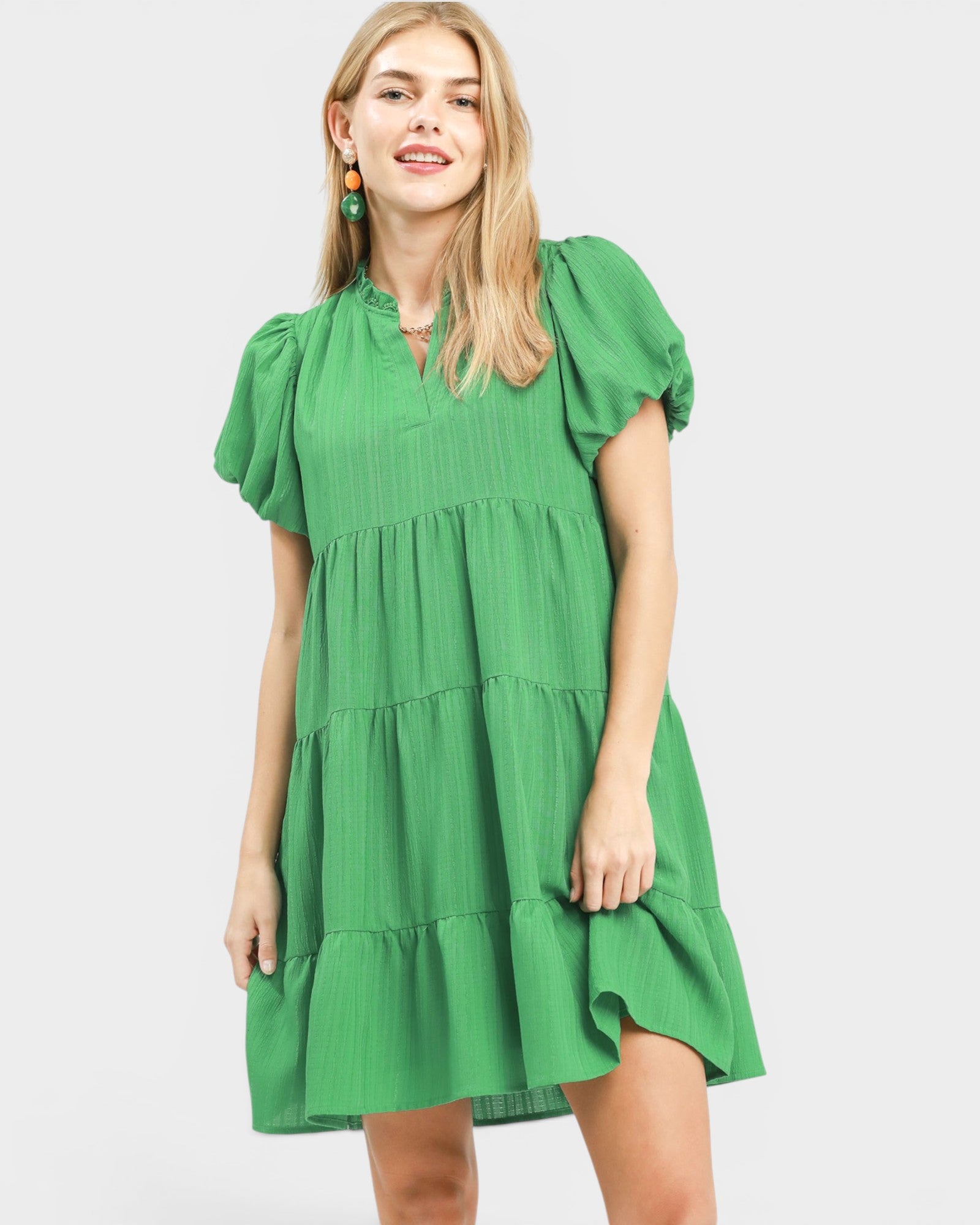 Woman wearing a green dress on a white background