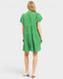 Green dress worn by a person on a white background