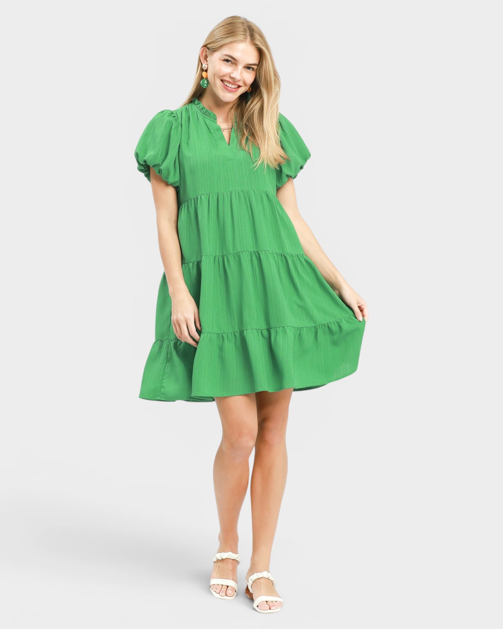 Woman wearing a green dress on a white background