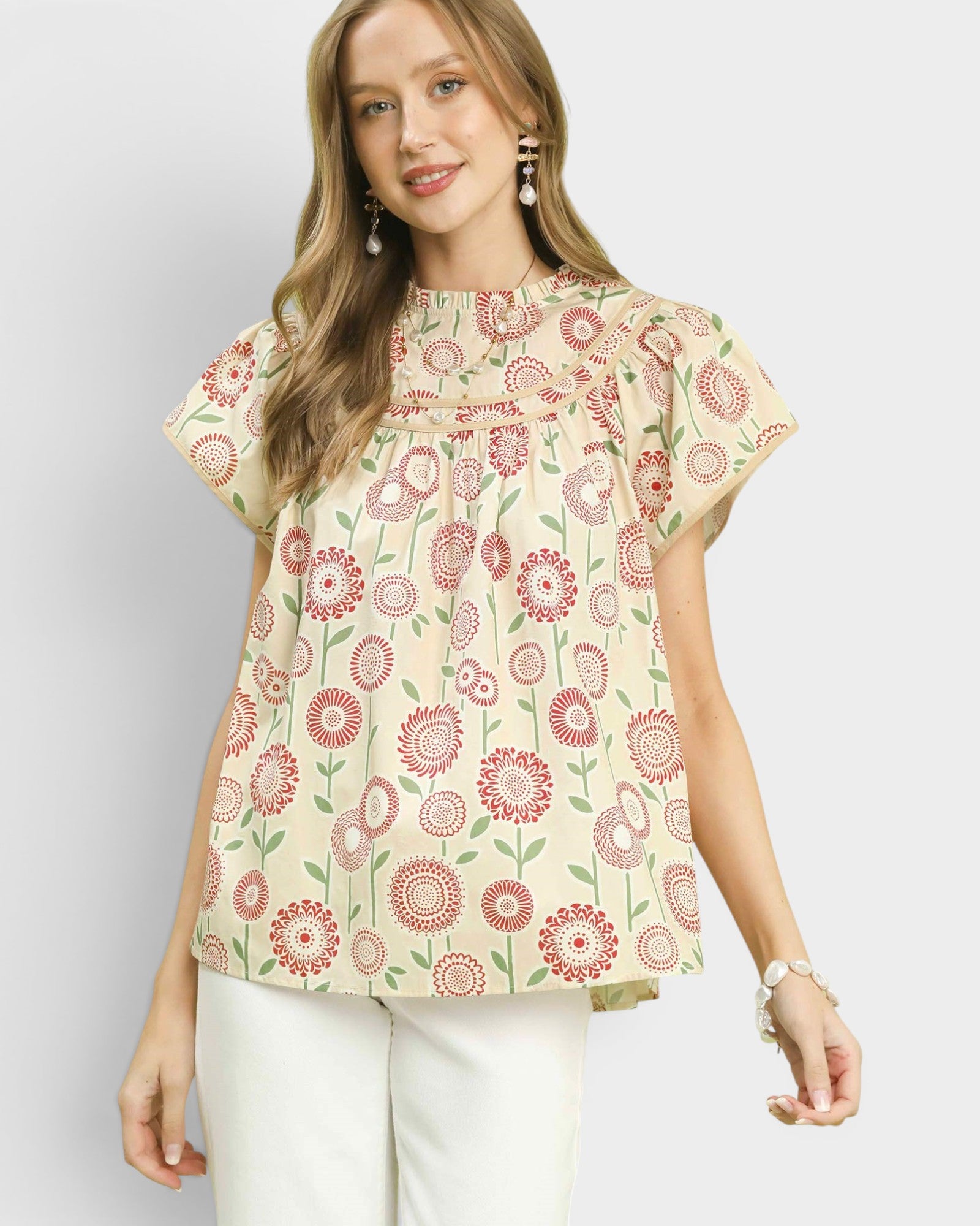 Woman wearing a floral blouse with a plain background