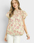 Woman wearing a floral blouse with a plain background