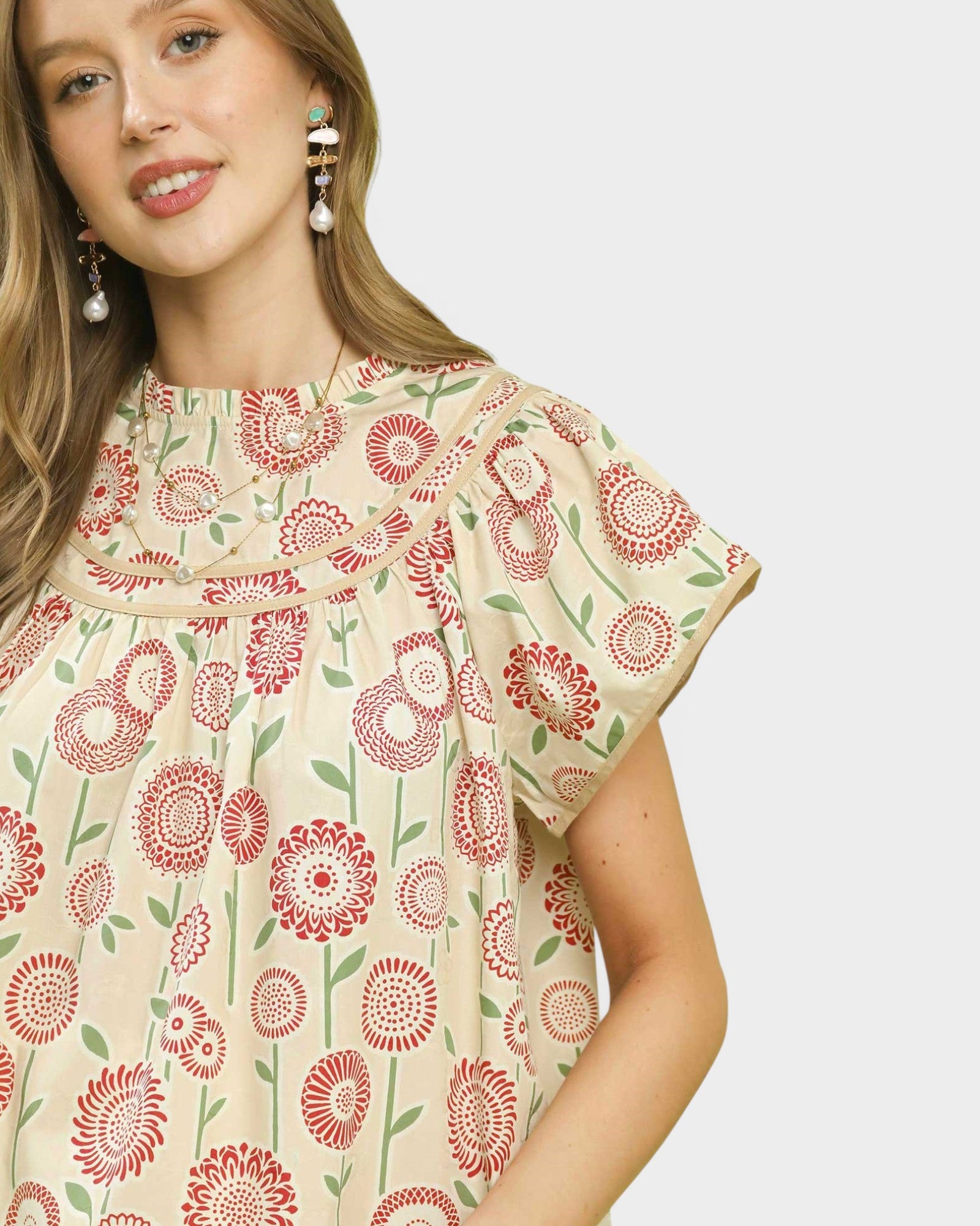 Woman wearing a floral dress with a plain background