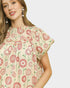 Woman wearing a floral dress with a plain background