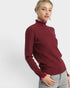 Woman wearing a burgundy sweater with pink trim on a white background