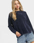 Woman wearing a navy sweater and denim shorts on a white background