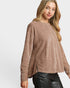 Woman wearing a brown sweater on a white background