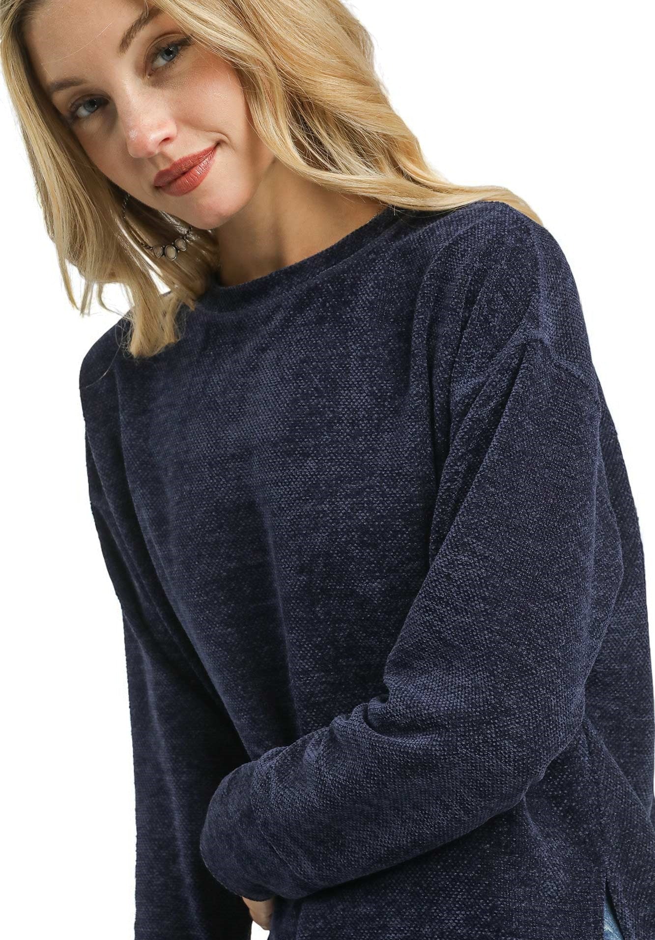 Woman wearing a navy blue sweater on a white background