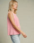 Woman wearing a pink and white striped sleeveless top against a neutral background