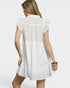 Woman wearing a white dress on a plain background