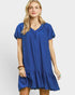 Woman wearing a blue dress with a plain background
