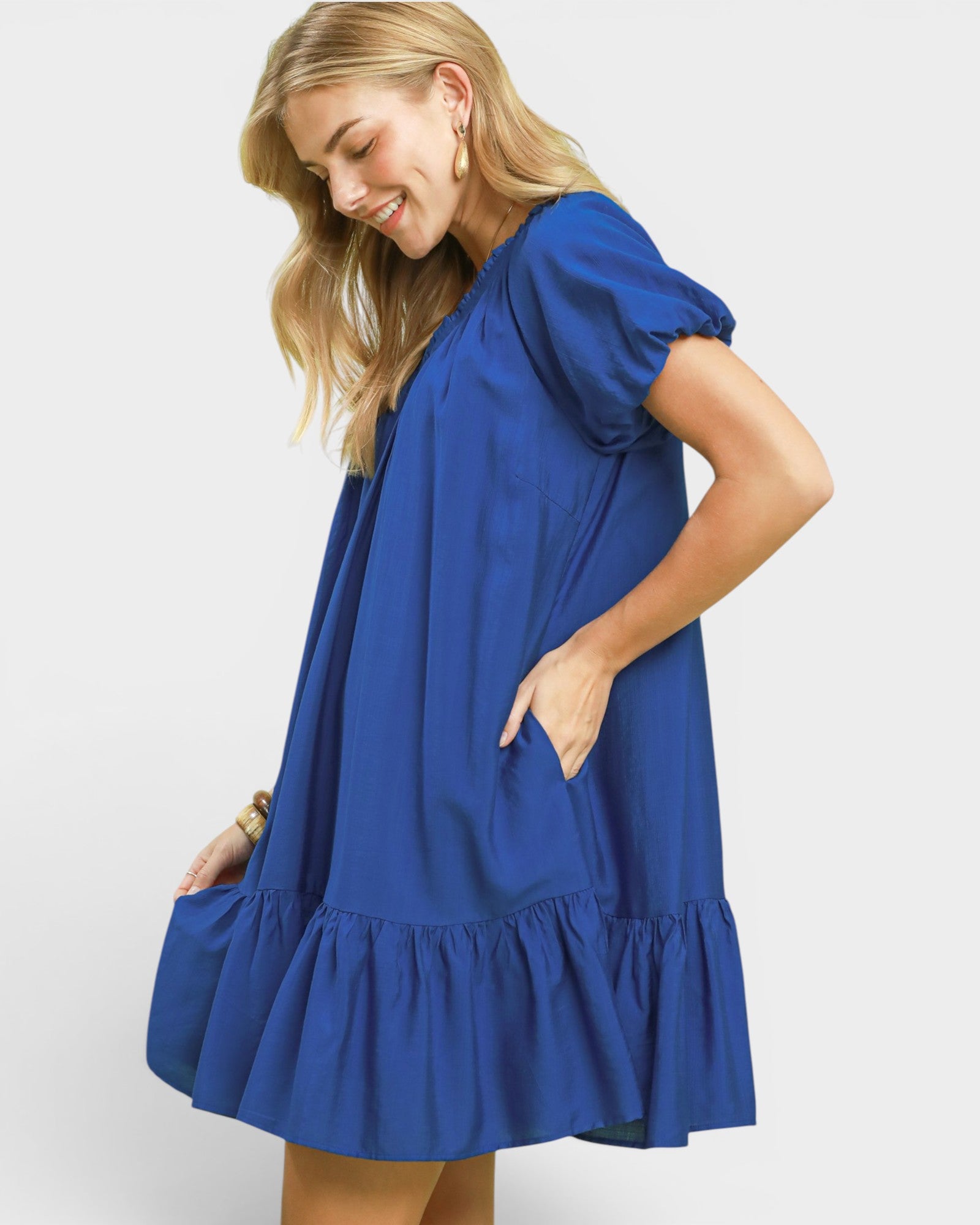 Woman wearing a blue dress on a white background