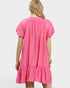 Pink dress worn by a person on a white background