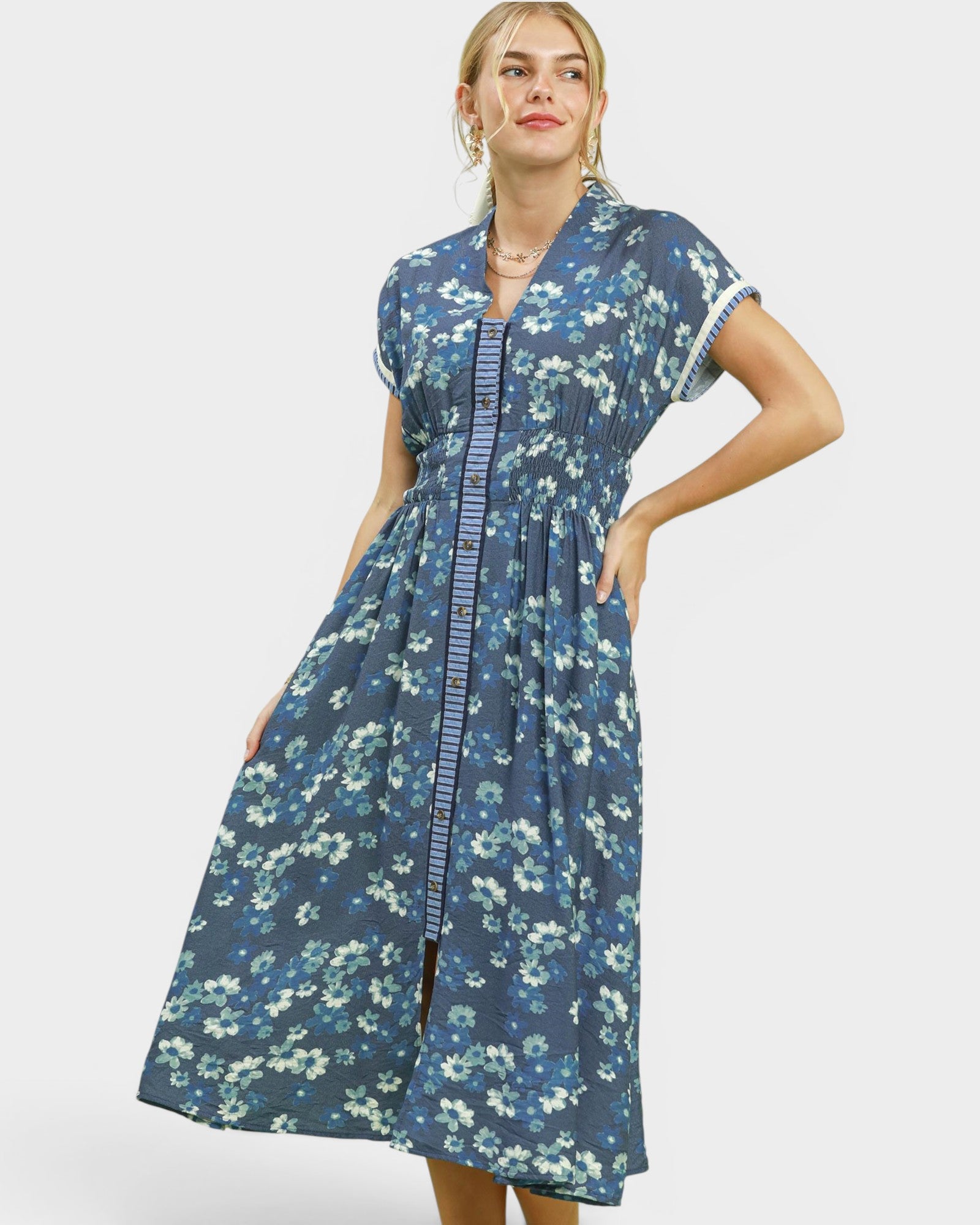 Woman wearing a blue floral dress on a white background
