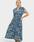 Woman wearing a blue floral dress on a white background