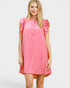 Woman wearing a pink dress with ruffled sleeves on a white background