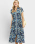 Woman wearing a blue floral dress with a white background