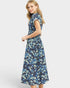 Woman wearing a blue floral dress on a white background
