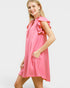 Woman wearing a pink dress with ruffled sleeves on a white background