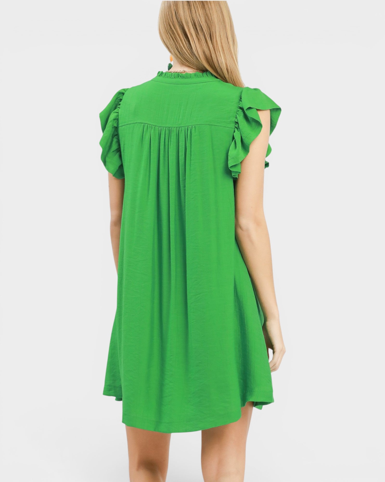 woman wearing a green mini dress