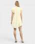 Woman wearing a light yellow dress on a white background