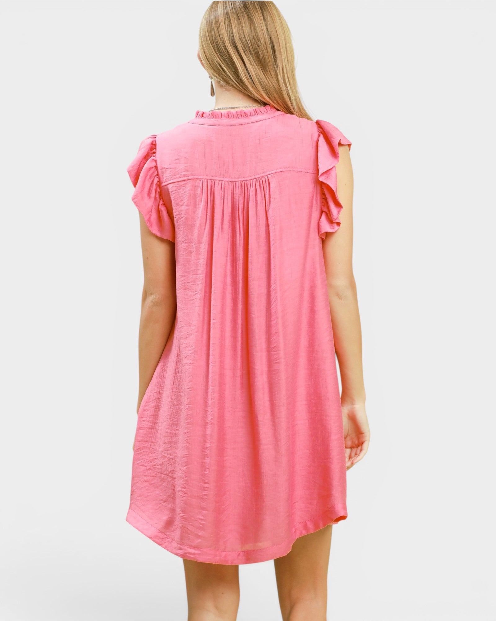Pink dress with ruffled sleeves on a white background