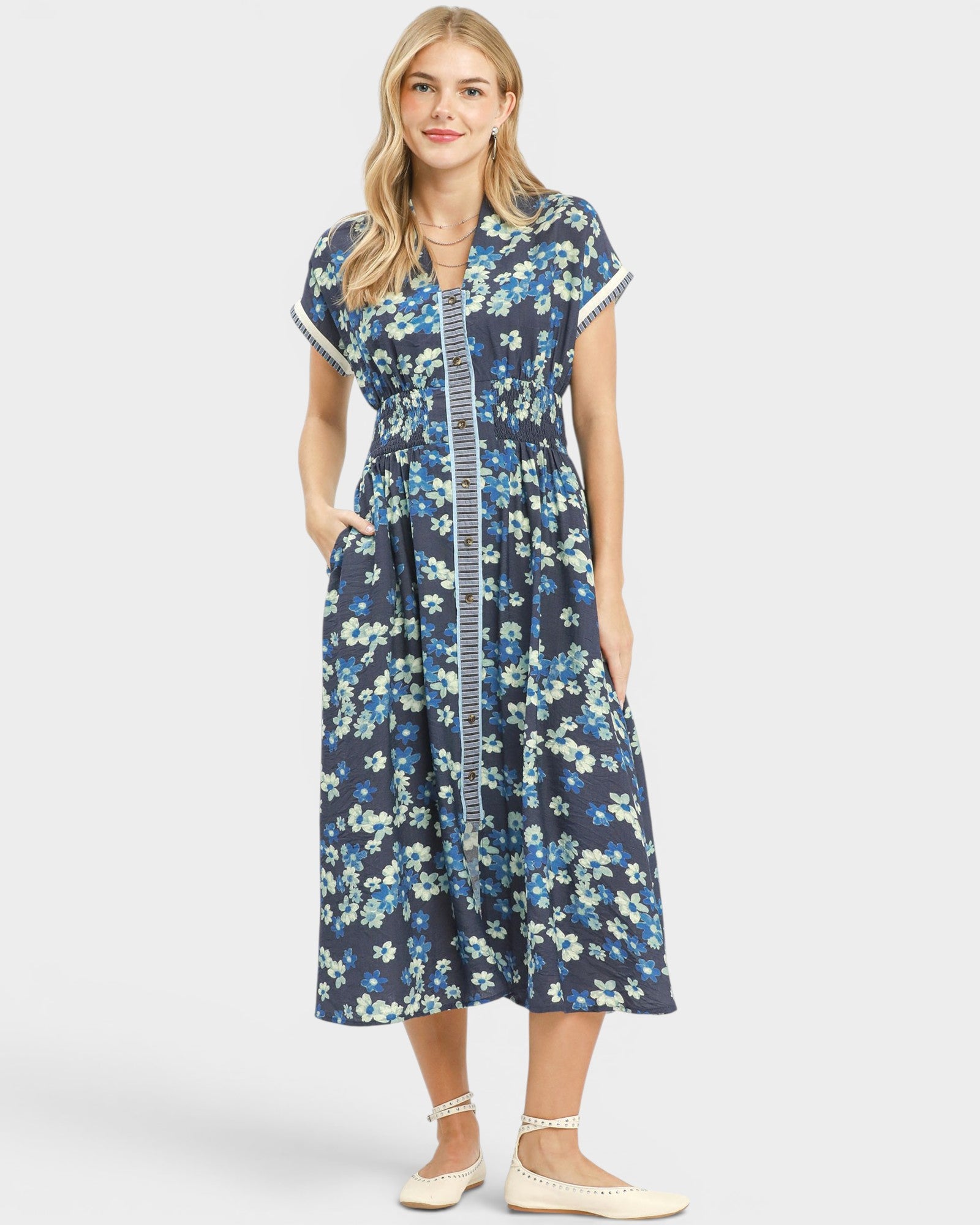 Woman wearing a blue floral dress on a white background