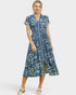 Woman wearing a blue floral dress on a white background