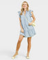 Woman wearing a blue checkered dress with ruffled sleeves on a white background