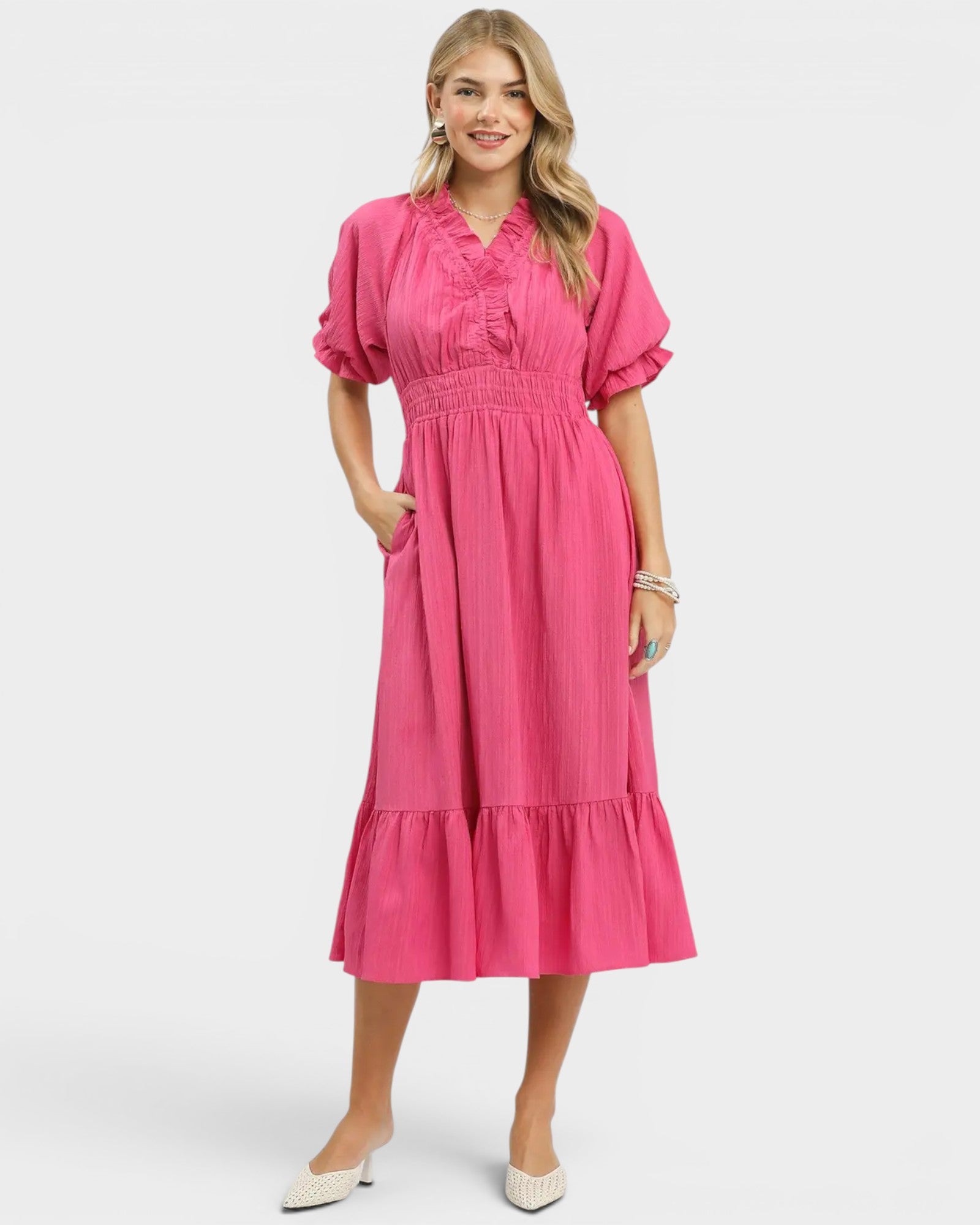 Woman wearing a pink dress on a white background