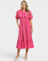 Woman wearing a pink dress on a white background
