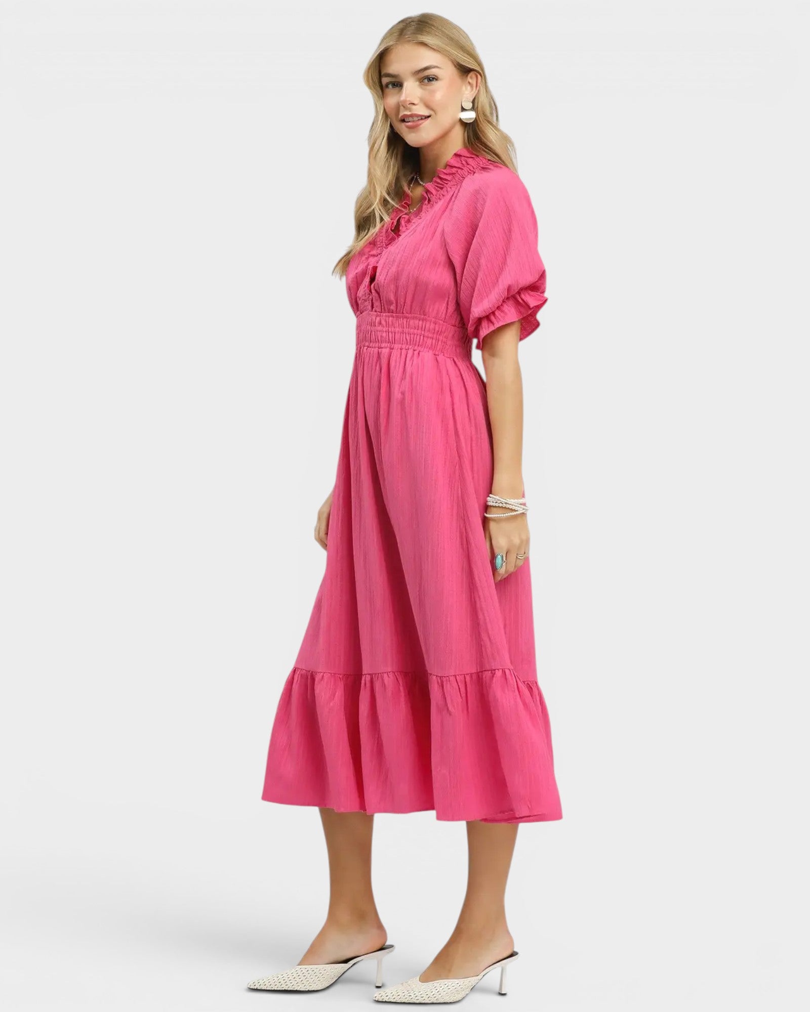 Woman wearing a pink dress on a white background