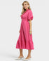 Woman wearing a pink dress on a white background