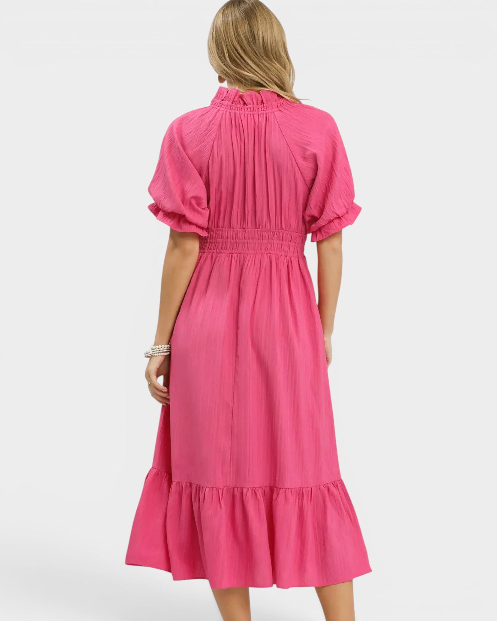 Pink dress worn by a person on a white background