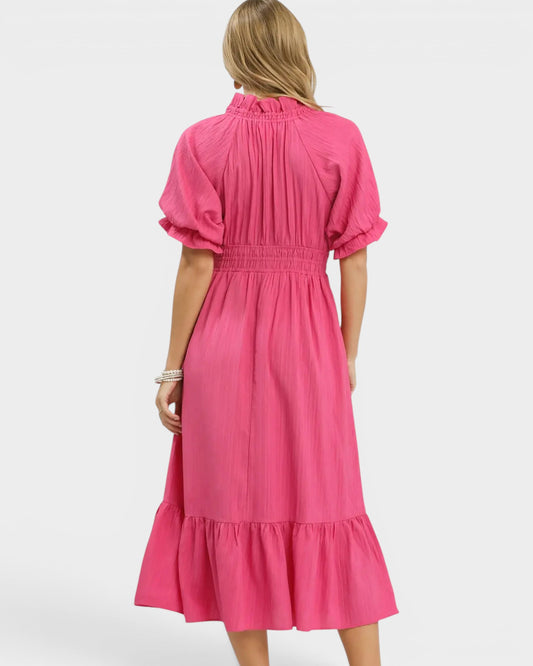 Pink dress worn by a person on a white background