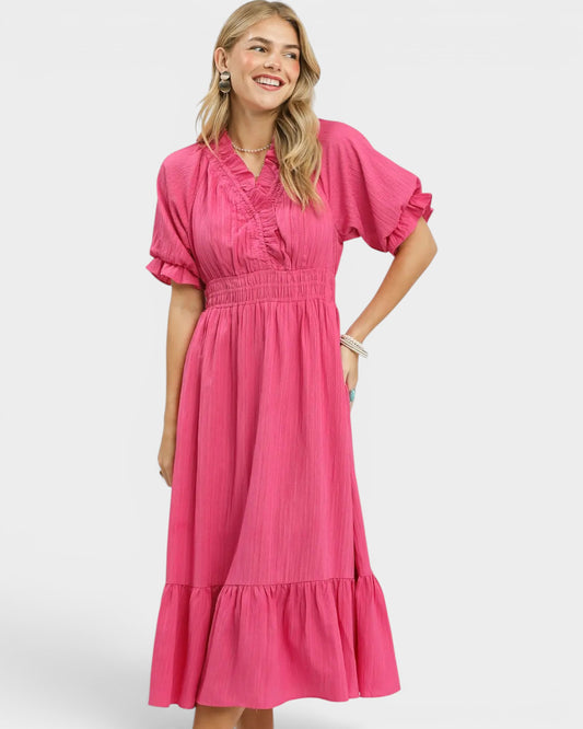 Woman wearing a pink dress on a white background