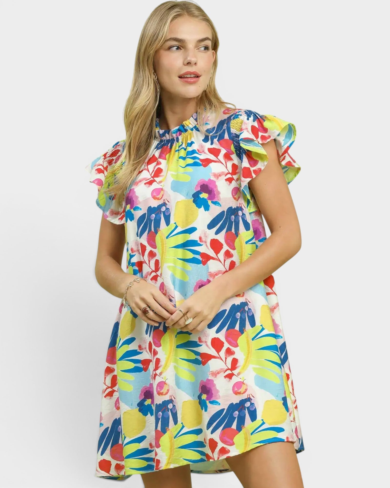Woman wearing a colorful floral dress on a white background