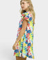Woman wearing a colorful floral dress on a white background