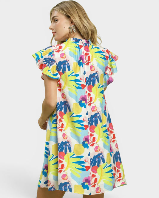 Woman wearing a colorful floral dress on a white background