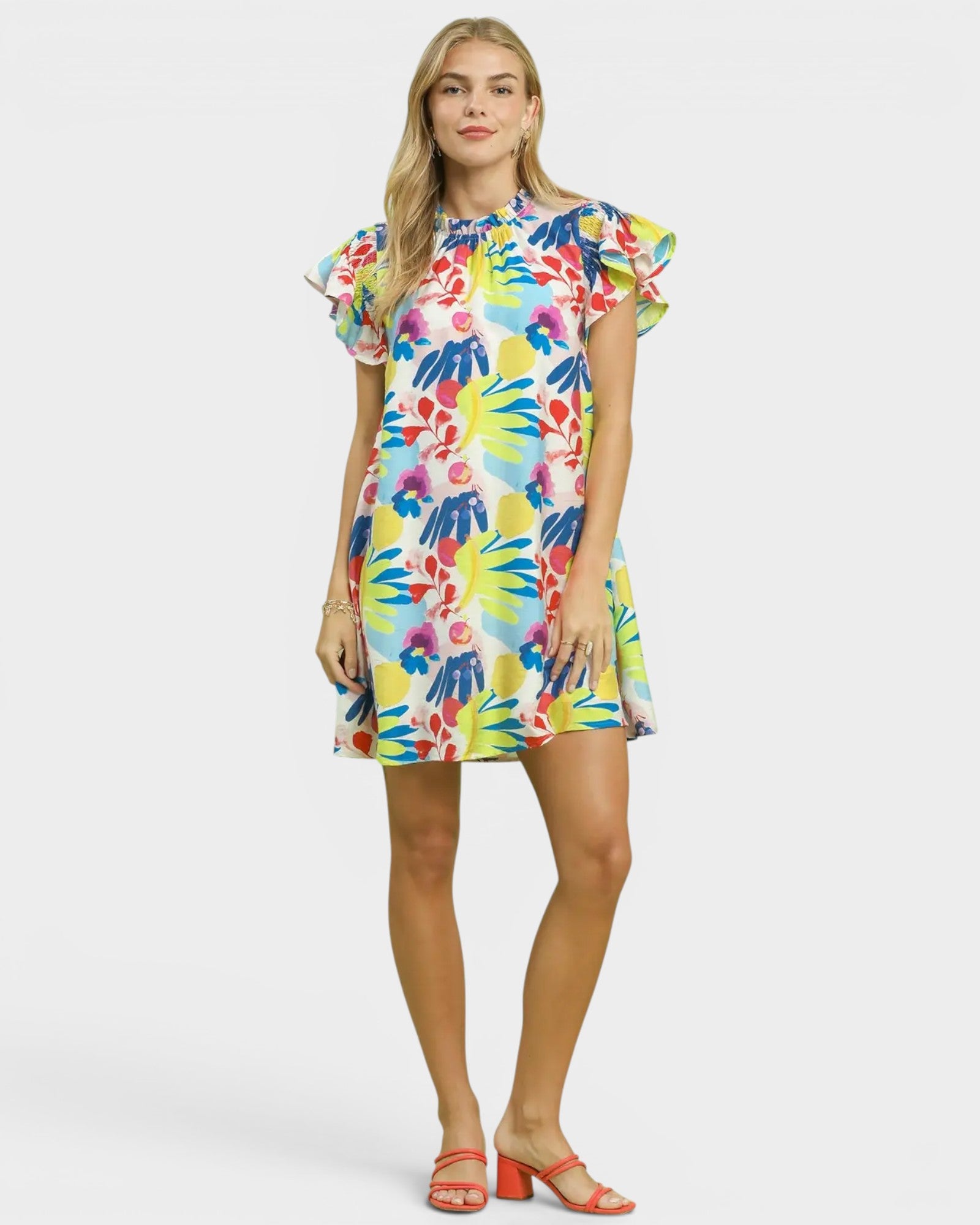 Woman wearing a colorful floral dress on a white background