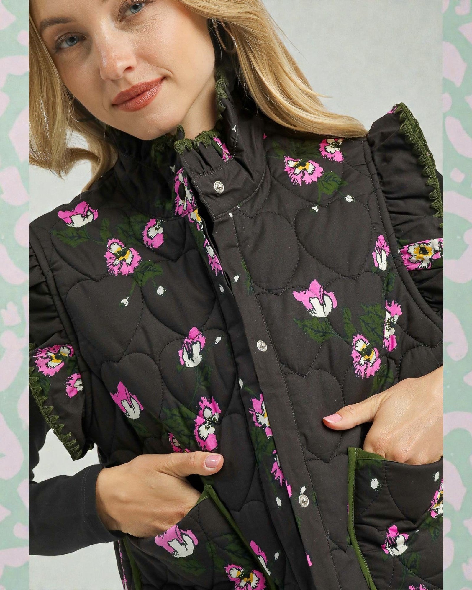 Woman wearing a black quilted jacket with floral embroidery on a light green background