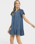 Woman wearing a blue denim dress on a white background
