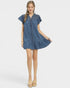 Woman wearing a blue denim dress on a white background
