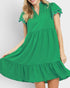 Green dress with ruffled details on a white background