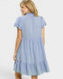 Woman wearing a light blue dress with lace trim on a white background
