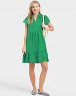 Woman wearing a green dress on a white background