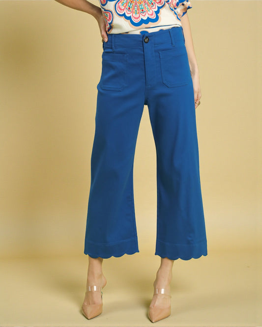 Blue wide-leg pants worn by a person on a beige background