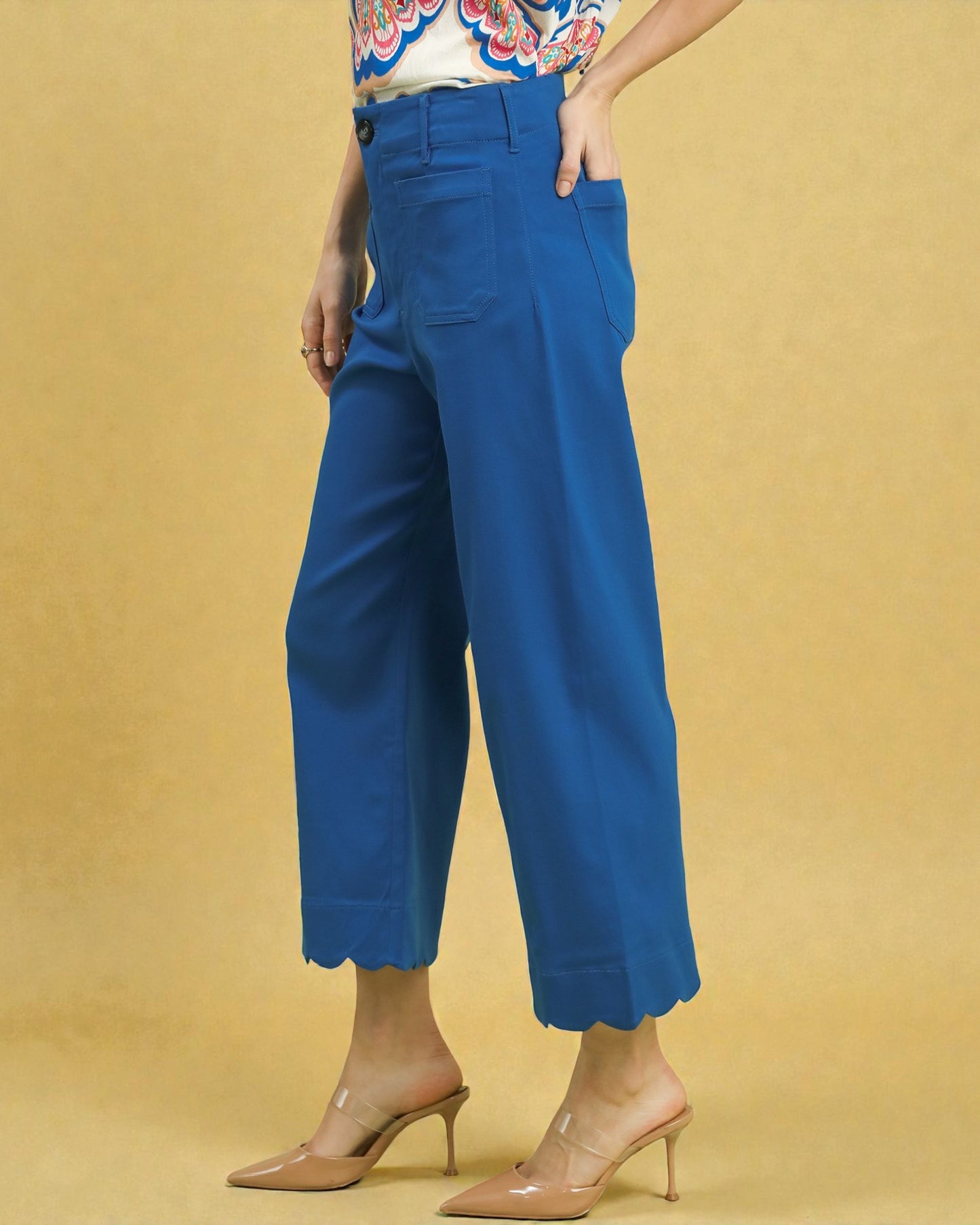 Blue wide-leg pants worn by a person on a beige background
