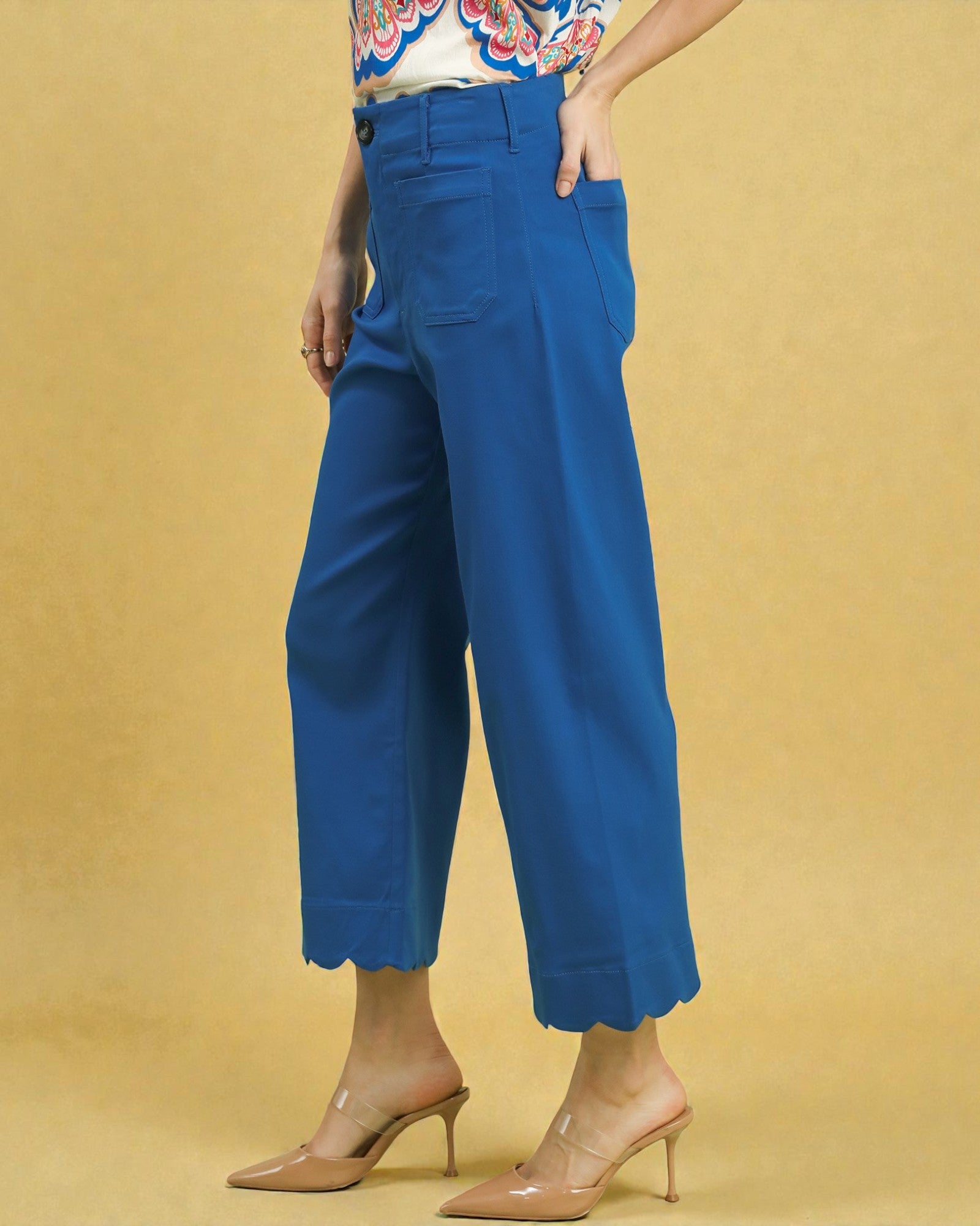 Blue wide-leg pants worn by a person on a beige background